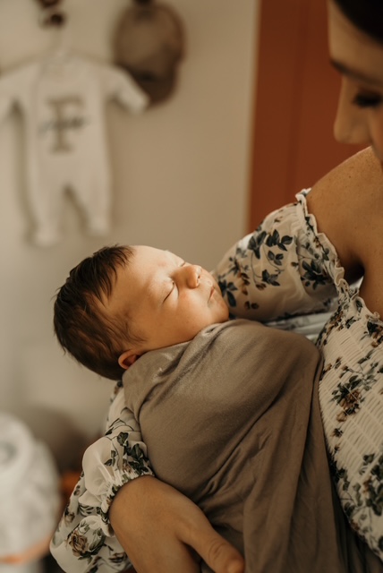 Newborn baby in her mother's arms