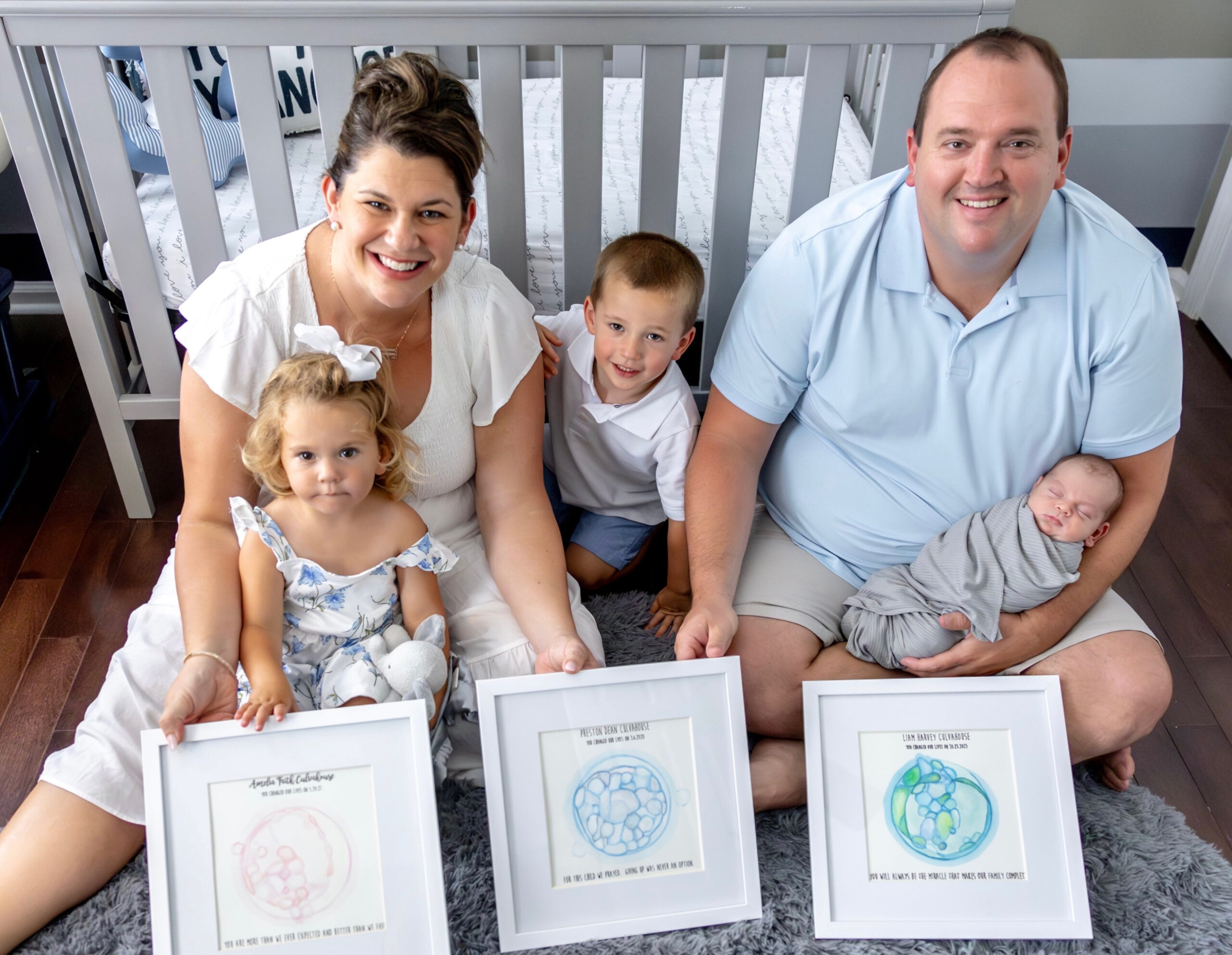 Mother and father with their two year old son, one year old daughter and newbor son.