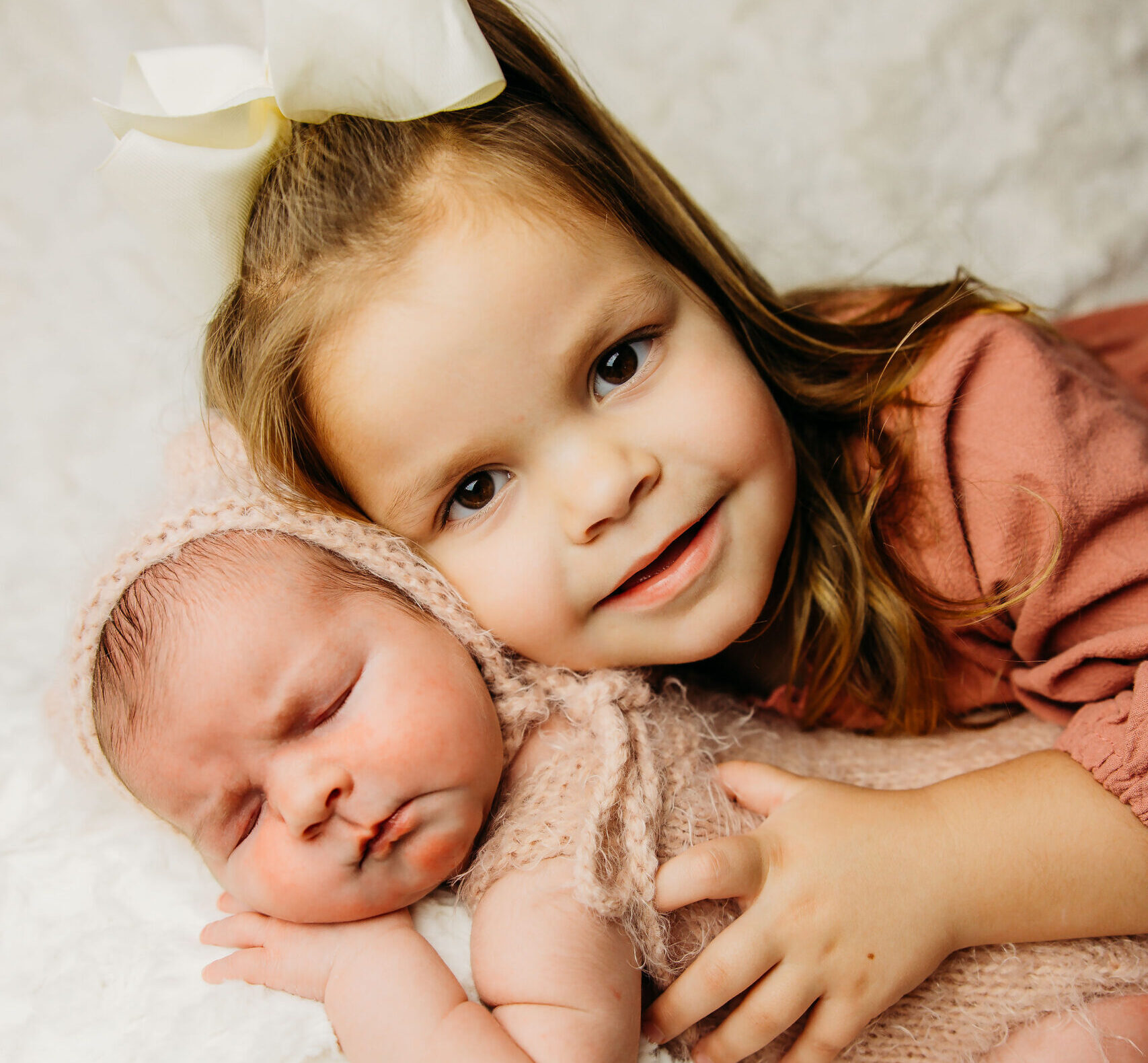 Three year old sister with her newborn sibling