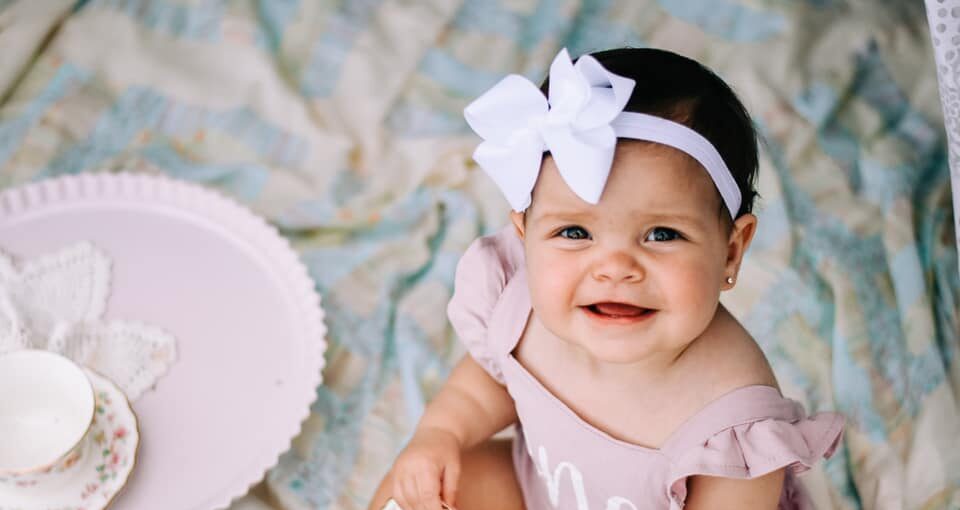 One year old baby girl smiling on her birthday