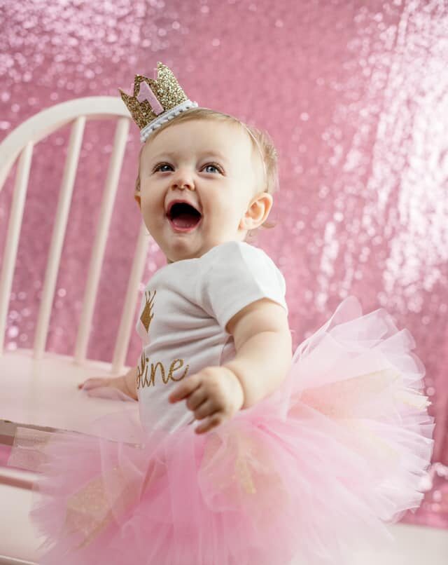 One year old baby girl dressed up for her first birthday