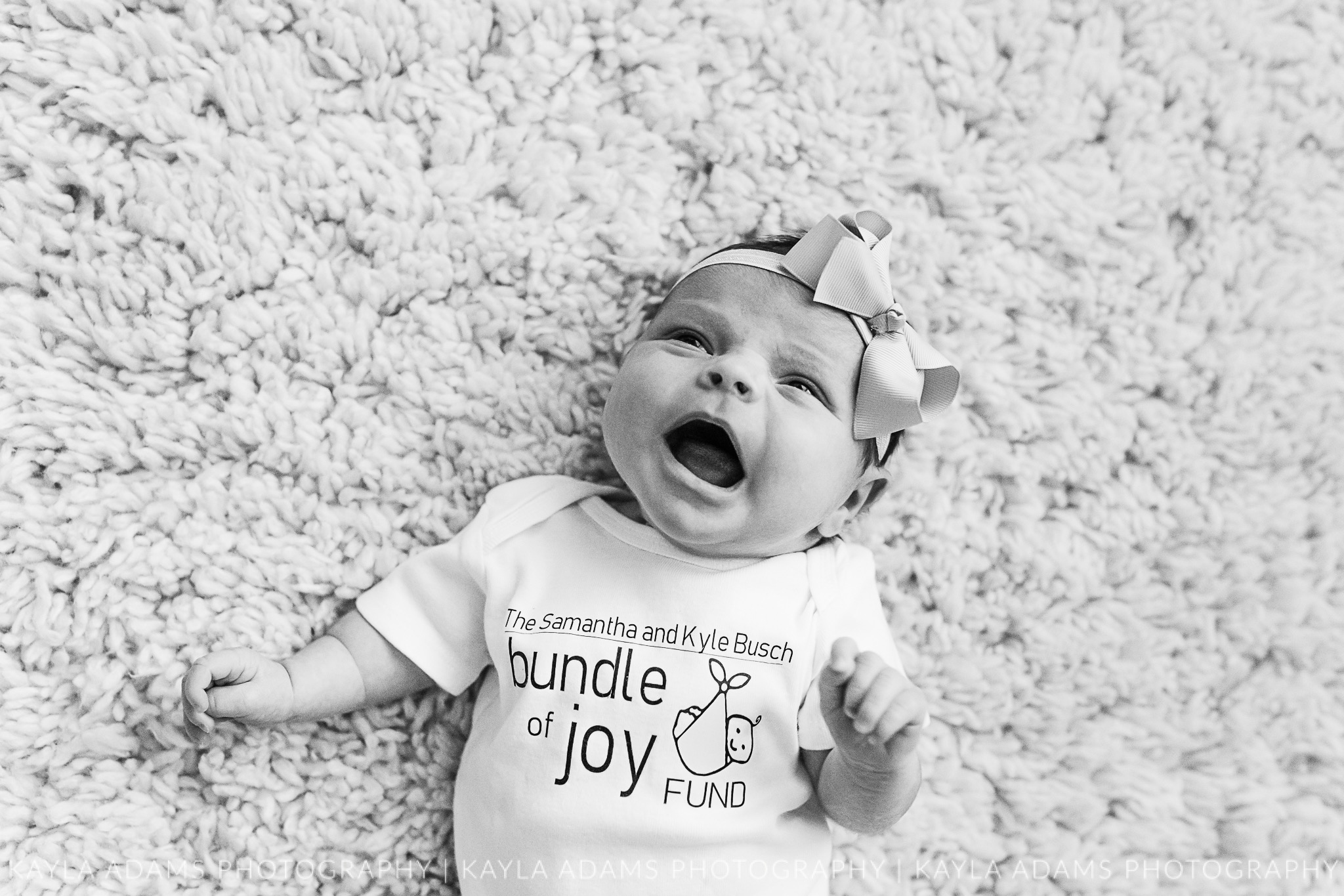 Newborn baby girl wearing a Bundle of Joy onesie