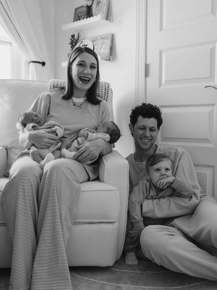 Mother and father with toddler son and twin newborns. Photoshoot in family nursery