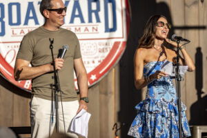 Samantha and Kyle Busch address the crowd on stage at the Boatyard Lake Norman event.